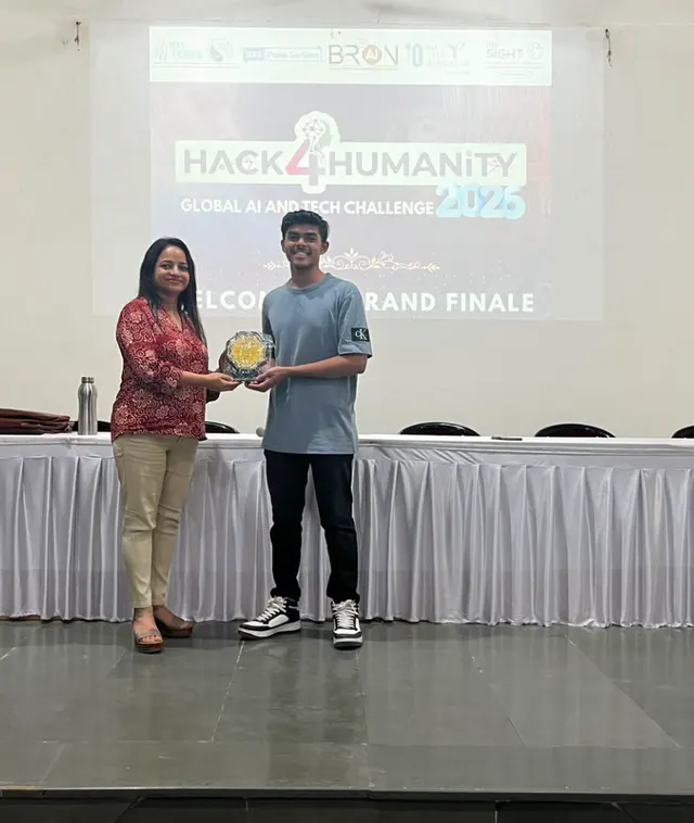 A memento being presented beneath a screen reading Hack4Humanity 2026, Welcome to the Grand Finale