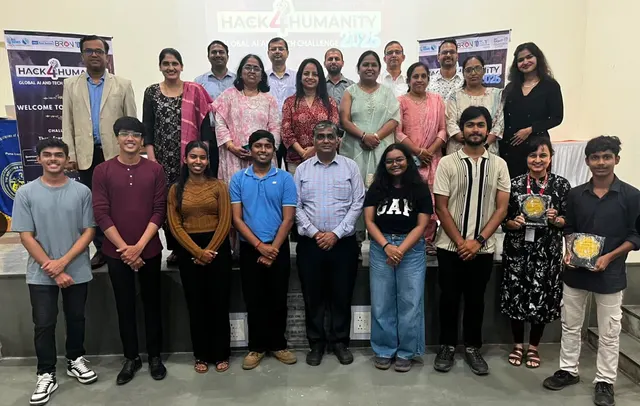 Students, faculty and guests on stage in front of the Hack4Humanity 2026 Global AI and Tech Challenge banners