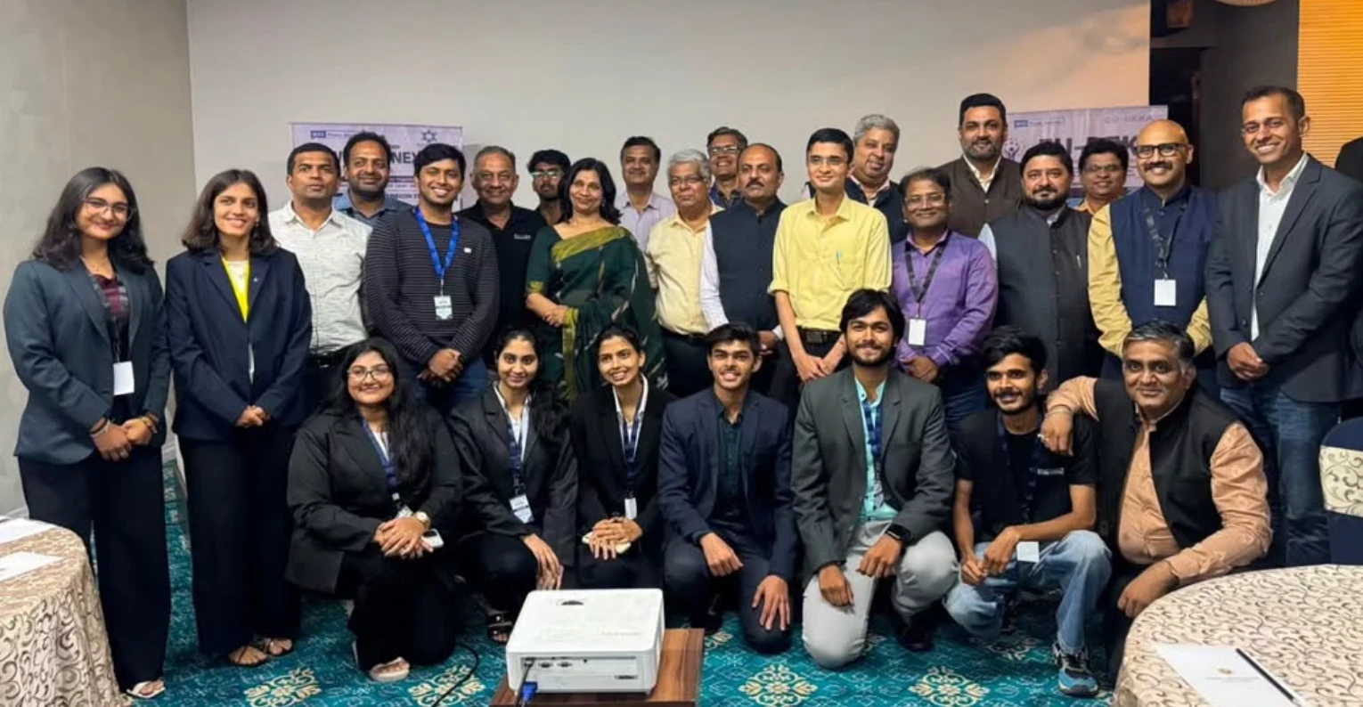 A large group of students and industry professionals with IEEE and Eu-Reka banners